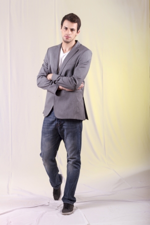 View of a young man standing against a white  background. の写真素材