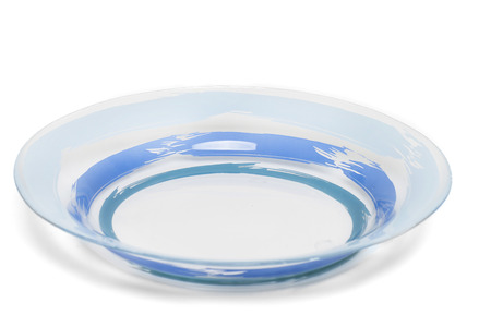 Close up view of a glass kitchen soup plate isolated on a white .の写真素材