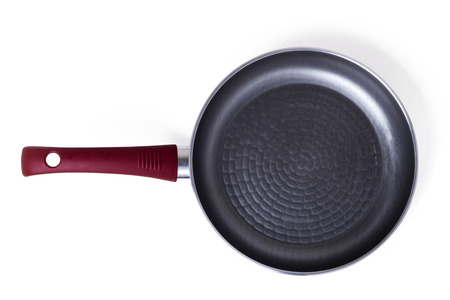 Close up view of a red frying pan with transparent cover isolated on a white background.の写真素材