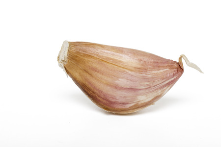 Close up view of a garlic clove isolated on a white background.の写真素材