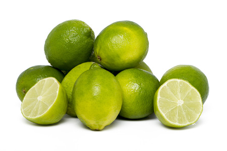 Close up view of a bunch of lime fruits isolated on a white .の写真素材