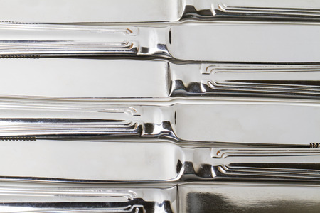 Close up view of kitchen table knifes isolated on a white .