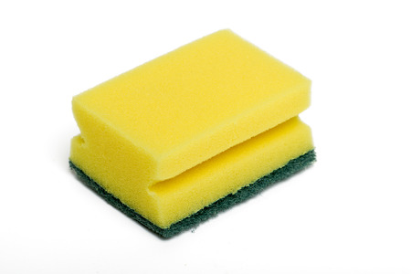 Close up view of a yellow cleaning sponge isolated on a white .の写真素材