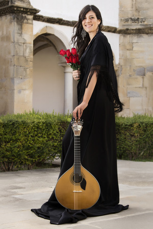view of a young beautiful singer and performer woman of traditional Portuguese Fado music.の写真素材