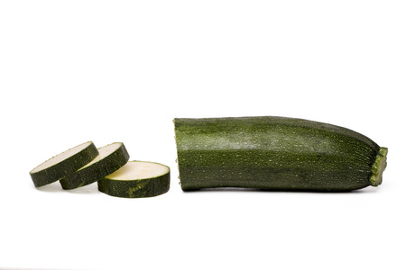 Close up view of a sliced courgette vegetable  isolated on a white background.の写真素材