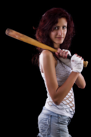 Fearful young street fighter girl on a black background.の写真素材