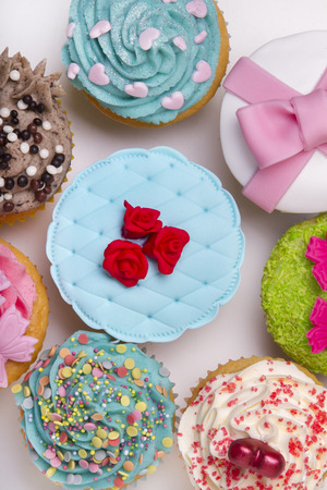 Close up view of original and creative cupcake designs isolated on a white background.の写真素材