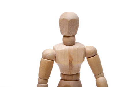 Close up view of a wooden dummy isolated on a white background.の写真素材