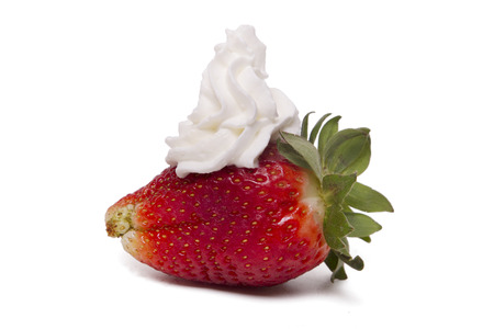 Close up view of a fresh strawberry with cream isolated on a white background.の写真素材