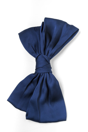 Close up view of a small blue tie for girls isolated on a white background.の写真素材