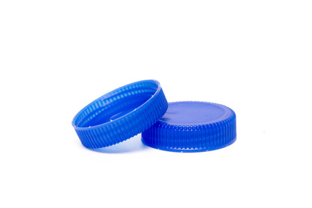 Close up view of a bunch of blue plastic caps from bottles of water isolated on a white background.の写真素材