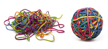 Close up view of a colorful elastic rubber band ball and a unordered pile isolated on a white background.の写真素材