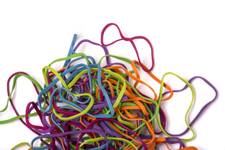 Close up view of a unordered pile of colorful elastic rubber bands isolated on a white background.の写真素材