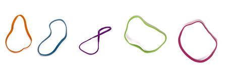 Close up view of a horizontal row of colorful elastic rubber bands isolated on a white background.の写真素材