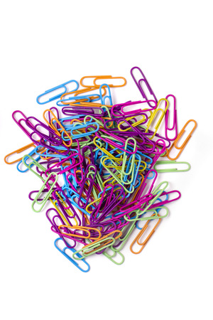 Close up view of a pile of several colorful office paper clips isolated on a white background.の写真素材