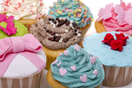 Close up view of original and creative cupcake designs isolated on a white background.の写真素材