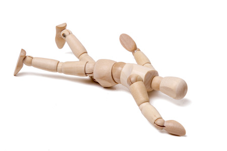 Close up view of a wooden dummy falling isolated on a white background.の写真素材