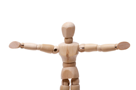 Close up view of a wooden dummy with arms wide open isolated on a white background.の写真素材