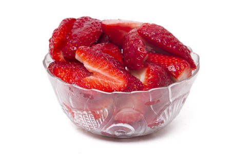 Close up view of fresh strawberry in a bowl isolated on a white background.の写真素材