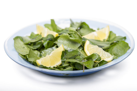 Close up view of a fresh and healthy watercress salad with lemon.の写真素材