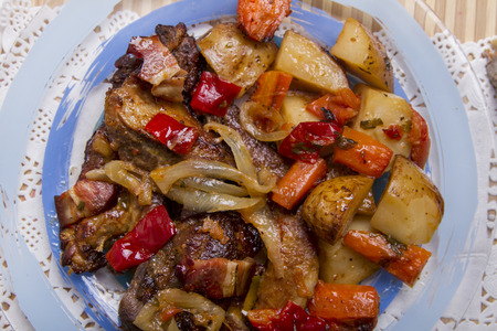 Close up view of oven baked meat with potatoes.の写真素材
