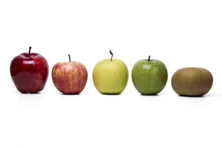 Close up view of several apples of different cultivars,  isolated on a white background.の写真素材