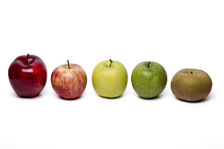 Close up view of several apples of different cultivars,  isolated on a white background.の写真素材