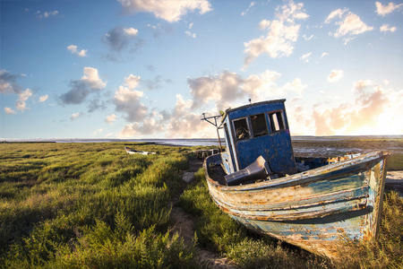 View of an old abandoned fishing boat on the marshlands.の写真素材