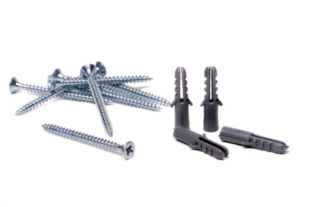 Close up view of a bunch of screws and plastic anchors isolated on a white .の写真素材