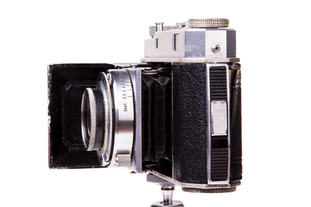 Close up view of a retro vintage photographic camera isolated on a white .