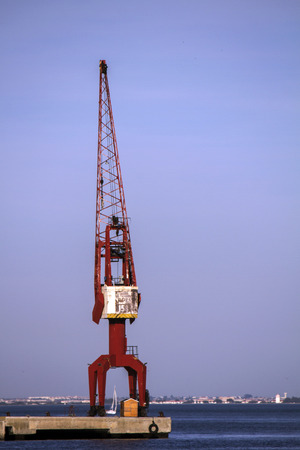 View of the Lisbon's commercial port cargo cranes in Portugal.