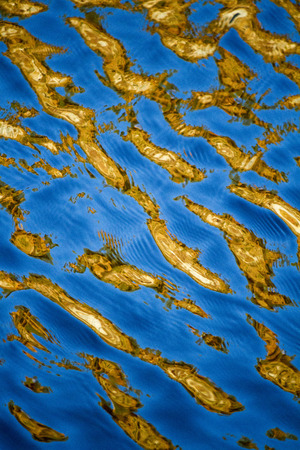 View of a texture of golden water.の写真素材