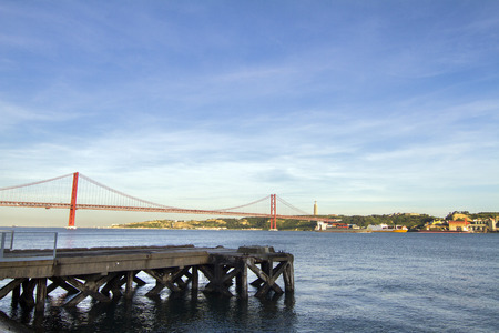 View of the famous portuguese bridge over the tagus river located in Lisbon, Portugal.の写真素材