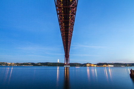 View of the famous portuguese bridge over the tagus river located in Lisbon, Portugal.の写真素材