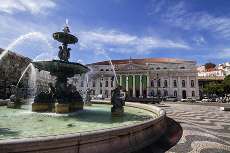View of the beautiful center fountain in the Rossio square and National Theater D.Maria II located in Lisbon, Portugal.のeditorial素材