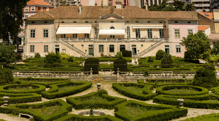 View of a beautiful classical building with a wonderful trimmed bush garden located on the Lisbon zoo, Portugal.のeditorial素材