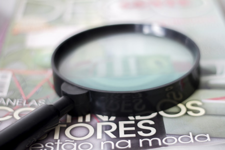 Close up view of a magnifying glass on a table.の写真素材
