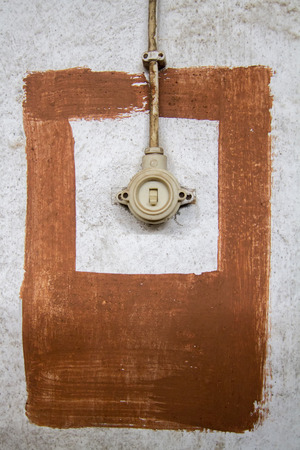 Close up view of an old retro electric switch on a wall.