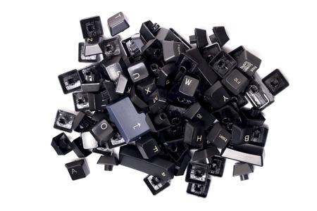 Pile of black computer keys on a white background.の写真素材