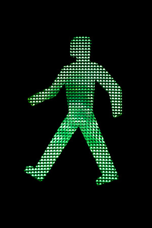 Close view of a pedestrian traffic light green man.