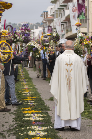 SAO BRAS DE ALPORTEL, PORTUGAL - April, 2015: Traditional religious procession of the flower torches event located in village of Sao Bras de Alportel, Portugal.のeditorial素材