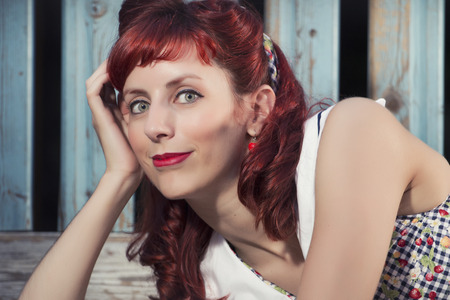 View of pinup young woman in vintage style clothing on a playground.の写真素材