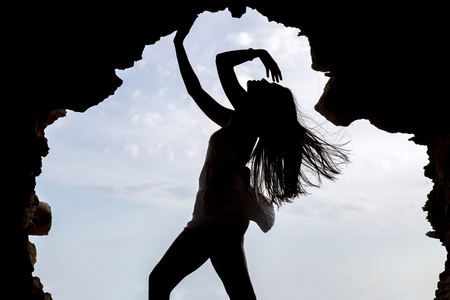 Close view of a silhouette of a beautiful woman on a dress.の写真素材
