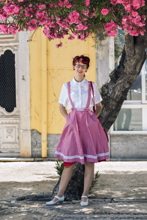 View of pinup young woman in vintage style clothing on the streets of Faro city.の写真素材