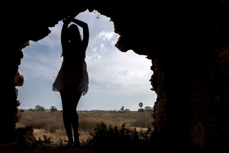 Close view of a silhouette of a beautiful woman on a dress.の写真素材