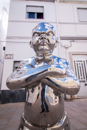 Close view of the famous tale of the boy with big eyes chrome statue in Olhao, Portugal.のeditorial素材