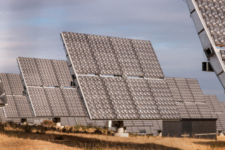 View of a field of photovoltaic solar panels gathering energy on the countryside.の写真素材