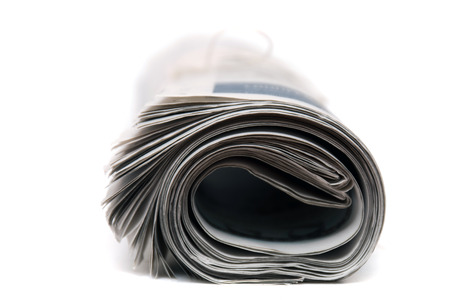 Close view of a rolled up newspaper with string isolated on a white background.の写真素材
