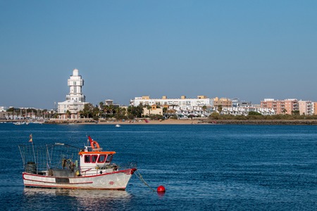 Summer view of the calm waters with sail boat and blue sky near Isla Cristina, Spain.の写真素材
