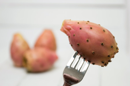 View of a Opuntia ficus-indica cactus fruits on a white wooden background.の写真素材